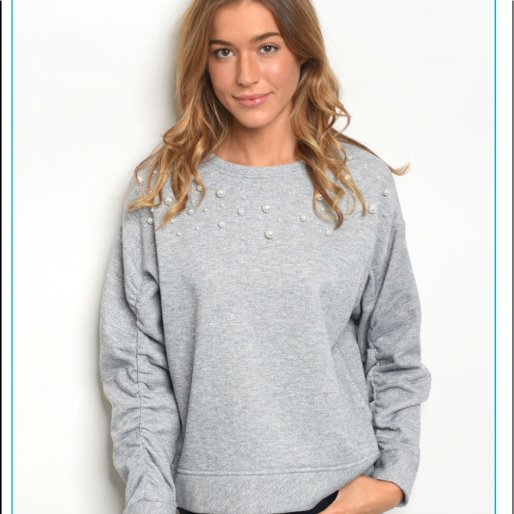 Grey sweat shirt with pearls around the top
